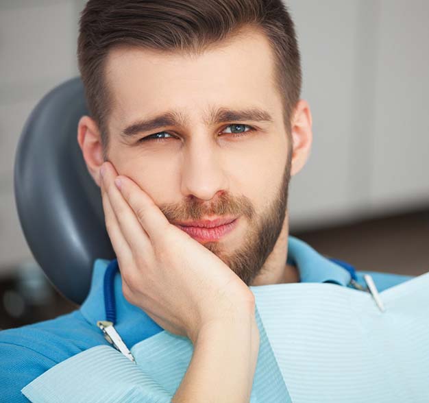 Man with a toothache visiting Jacksonville emergency dentist