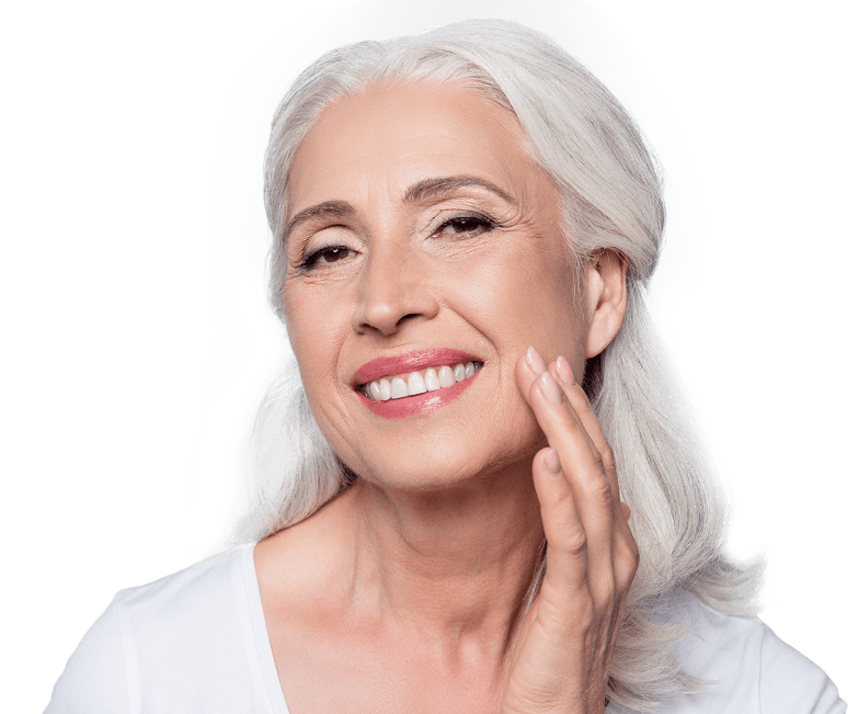 Older woman with dental implants in Jacksonville touching her face