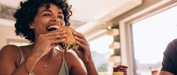 Jacksonville patient enjoying food with Invisalign trays removed