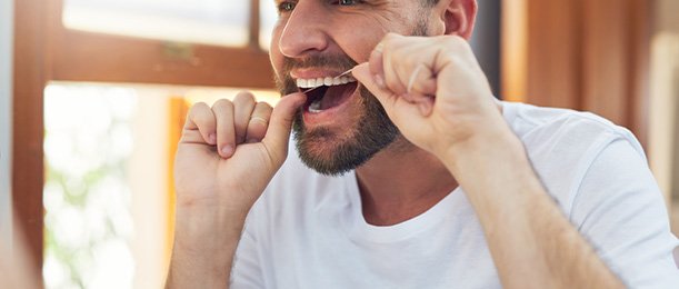 Jacksonville patient flossing with aligners off