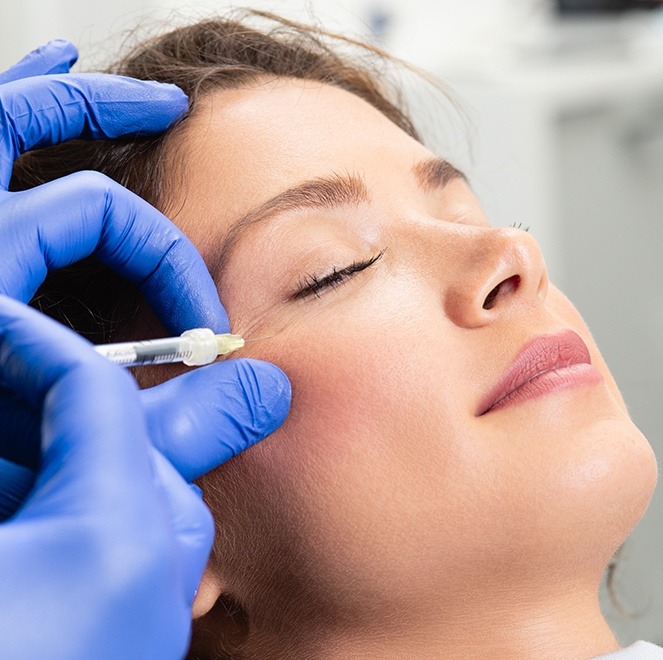 Woman receiving Botox treatment for TMJ pain