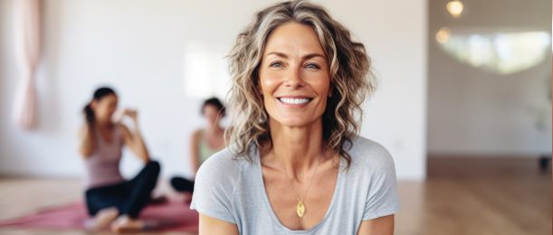 Smiling mature woman sitting on the floor